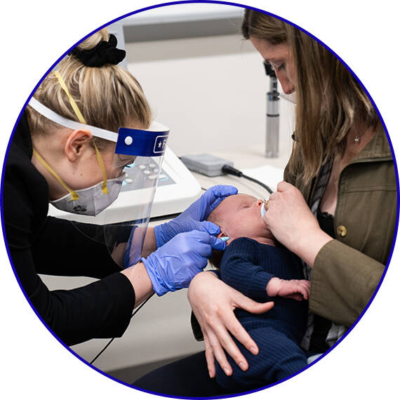 Audiology student conducting a hearing exam on a pediatric Standardized Patient.
